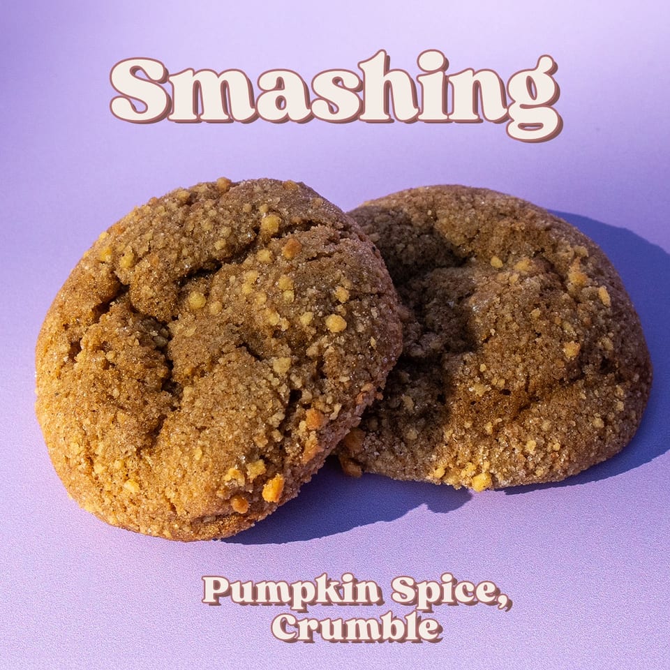 Two pumpkin spice crumble cookies on a purple background, labeled “Smashing” and “Pumpkin Spice, Crumble.”